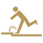 Gold icon of a person tripping on a raised curb.