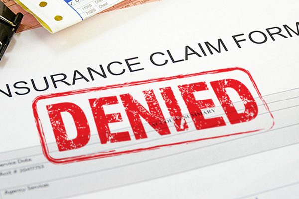 Red denied stamp on an insurance claim form