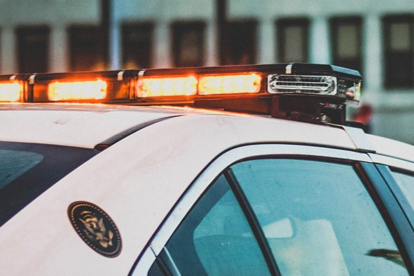 Red lights flashing on top of a police car