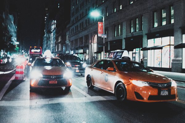 Yellow taxi cabs on busy street at night