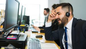An insurance adjuster on the phone with a client, pressuring them into making a quick decision.