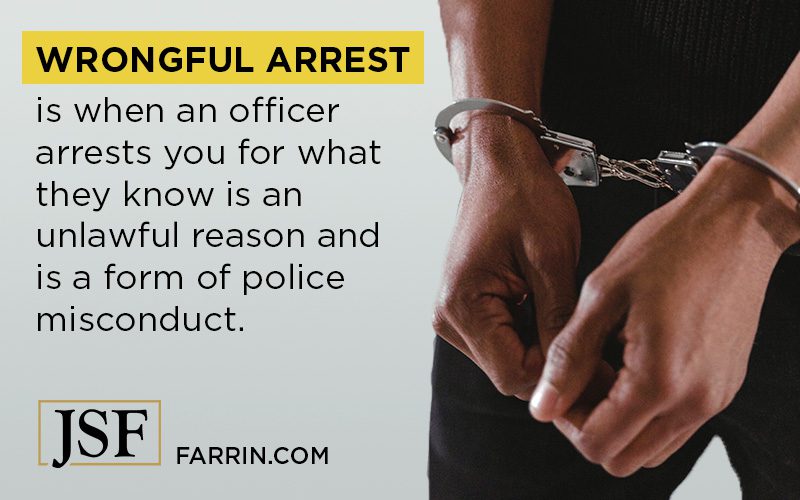 Person holding out their hands with handcuffs around their wrists.