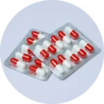 Two blister packs of medicine in capsule form.