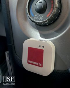 A bluetooth safe driving device installed on the center console of a car.