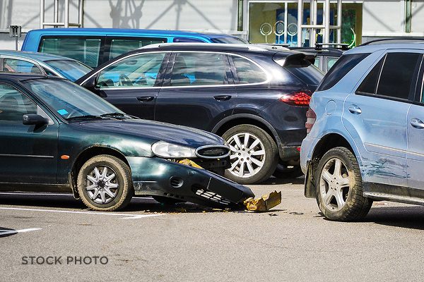 Law Offices of James Scott Farrin car accident attorneys in the Carolinas. Two vehicles with front-end damage after collision in parking lot.