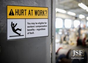 Law Offices of James Scott Farrin Greensboro NC workers’ compensation firm. Safety sign highlights workers’ comp rights for injured employees.